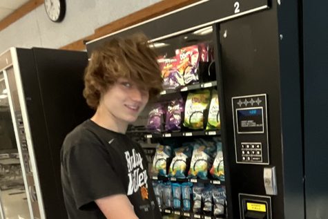 Reporter Nick D. contemplates which snack to get from the vending machine.