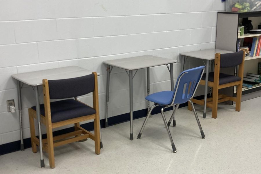 Students+serving+lunch+detention+sit+in+a+small+quiet+room+facing+the+wall.+